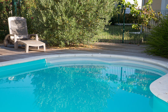 Swimming pool with blue transparent water in a garden area
