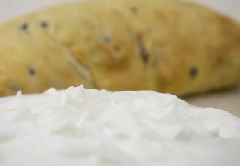 Sour cream on the background of bread.