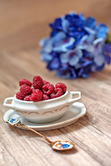 Berries of fresh juicy raspberry on a light background