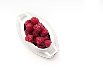 Berries of fresh juicy raspberry on a light background
