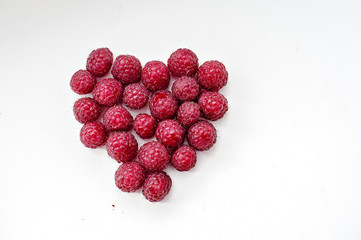 Berries of fresh juicy raspberry on a light background