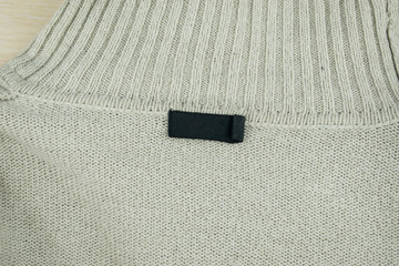 A black tag on a sweater.