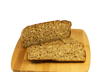 Sliced rye bread on cutting board. Whole grain rye bread with seeds. Delicious whole grain bread.