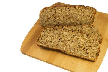 Sliced rye bread on cutting board. Whole grain rye bread with seeds. Delicious whole grain bread.