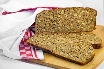 Sliced rye bread on cutting board. Whole grain rye bread with seeds. Delicious whole grain bread.
