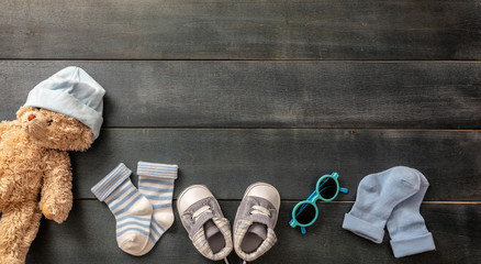 Baby boy shoes and socks on blue wooden background
