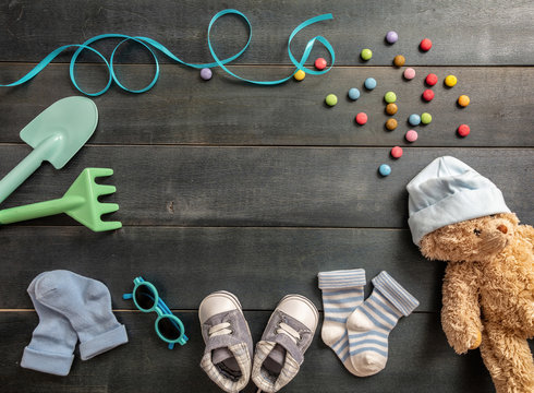 Baby boy shoes and socks on blue wooden background