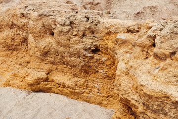 closeup of stone on the beach, sea coast with high hills, beautiful wild landscape