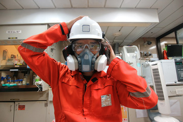 Multi-purpose respirator half mask for toxic gas protection.The man prepare to wear Multi-purpose...