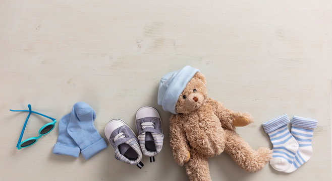 Baby boy shoes and socks on wooden background - Powered by Adobe