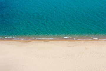 aerial view of sandy beach and blue sea