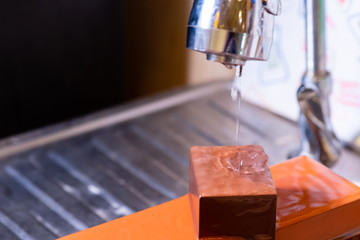 woman professional chef hands hold knife for whetting on whetstone.premium professional stone from japan.knife sharpening process with traditional sharpener stone for knife sharpen edge in restaurant.