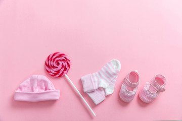 Baby girl shoes and socks on pink background