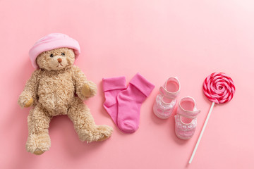 Baby girl shoes and socks on pink background