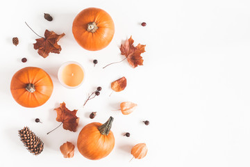 Autumn composition. Pumpkins, candles, dried leaves on white background. Autumn, fall, halloween concept. Flat lay, top view, copy space - obrazy, fototapety, plakaty
