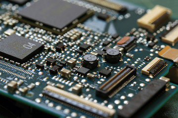 Electronics background technology close up of the green kit circuit board. Application Specific Integrated Circuit.