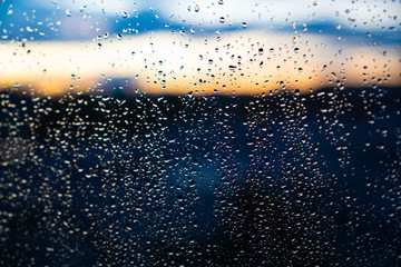 Naklejka na ściany i meble closeup of raindops on window in the evening