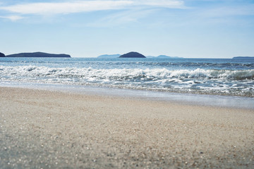 Fototapeta na wymiar Coast of the sea with beautiful sand on a sunny day.