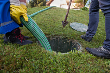 Emptying household septic tank. Cleaning and unblocking clogged drain.