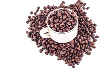 Cup of coffee full of coffee beans isolated on white background, side view