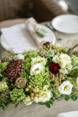 Wedding flower arrangement of flowers and greensin glass vase. Close up. Selective focus. Wedding Banquet or gala dinner. party on terrace
