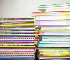 Two piles of colorful books.