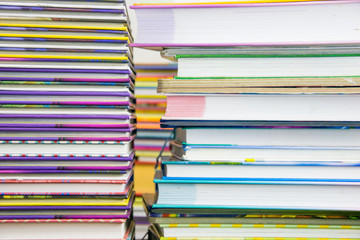 Two piles of colorful books.