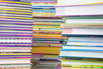 Two piles of colorful books.