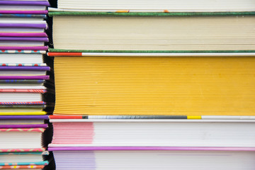 Two piles of colorful books.