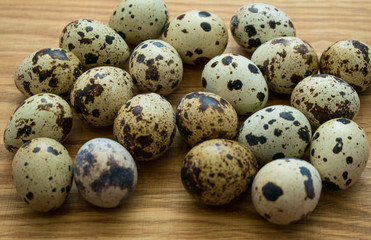 Quail eggs on a wooden background.