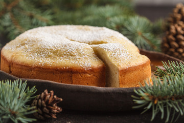 Christmas pie in Christmas decorations, dark background.