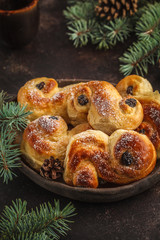 Obraz na płótnie Canvas Traditional Swedish Christmas saffron buns (lussebulle or lussekatt). Swedish christmas.