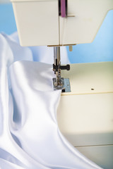 Sewing machine and white satin fabric