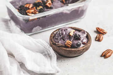 Vegan blackberry ice cream with pecan and coconut cream.