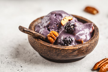 Vegan blackberry ice cream with pecan and coconut cream.