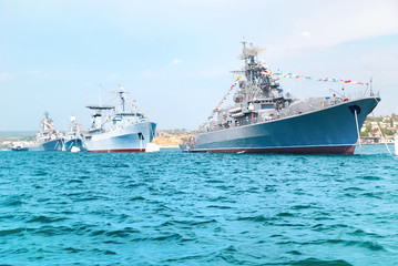 Fototapeta na wymiar Military navy ships in order on blue sea