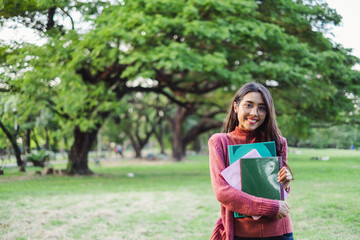 portrait asian young teen student standing in park for studying and education concept