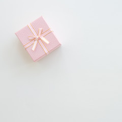 Pink gift or present box on table from above.