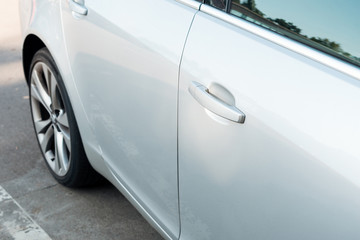 detail of parked shiny white car, transport background