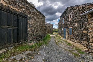 Traditional slate buildings in El Muyo black village of the Riaza district in the province of Segovia (Spain)