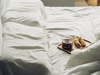 Obraz na płótnie Canvas Breakfast set of Thai sweet roti and hot cocoa served on bed.