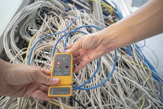 Technician is checking netwoek wires in data center