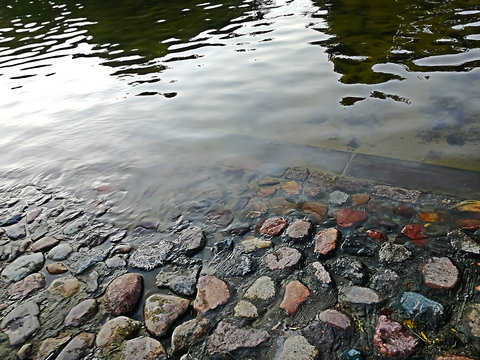 background of pond in the park with beautiful stones
