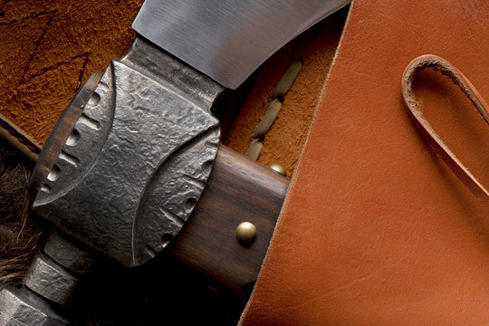 Close up of a tomahawk head in a leather case