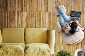 Freelancer using laptop for business analysis relaxed at home
