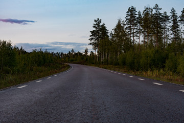 tarmac road turning left on a summer evening in sweden 2018