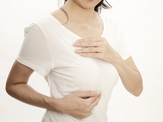 Woman examining herself for breast cancer