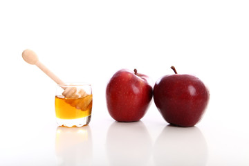 honey jar with red apple white background studio