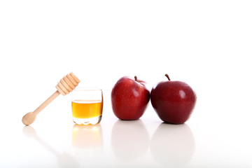 honey jar with red apple white background studio