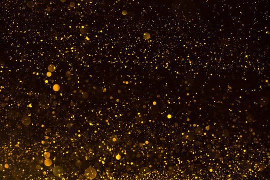 Shiny gold glitter particles abstract background